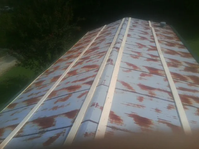 Rusted metal roof panels with new wood purlins before replacement — Storm Damage Roof Repair in Rohnert Park by Roofing Brothers