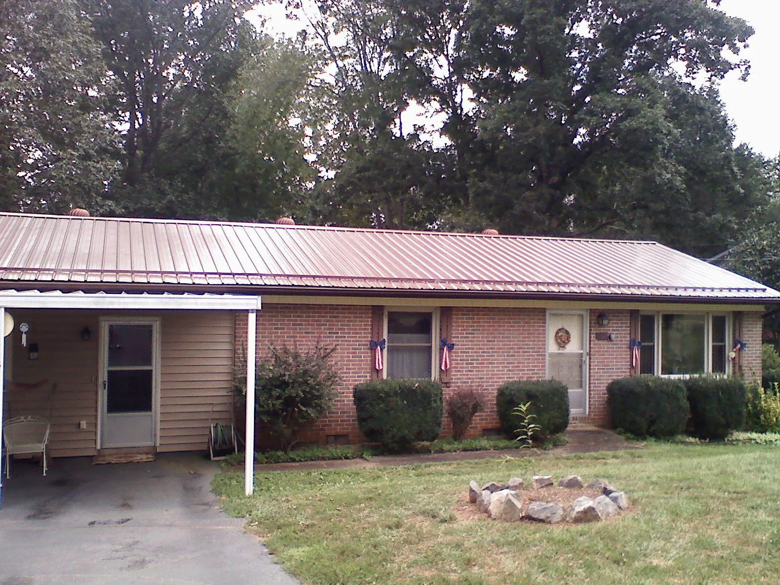 Bronze metal roof and carport on a brick ranch home — Roof Repair work by our crew in Rohnert Park